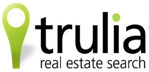 This picture is a logo for trulia real estate search. There is a picture of a pin point and the dot on the I is green.