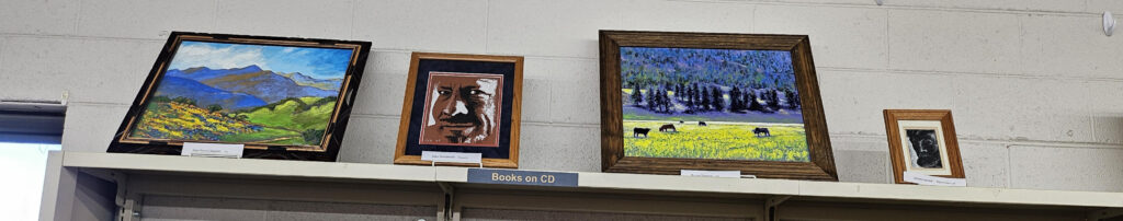 Eric Matranga's art set on top of a library book shelf