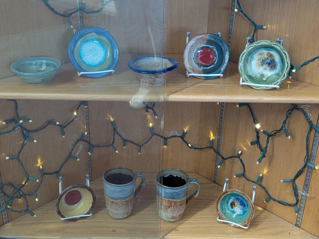A collection of pottery pieces in the library's display case